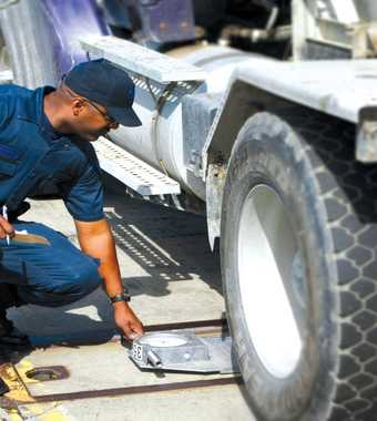 Motor Carrier Officer checking weight of truck